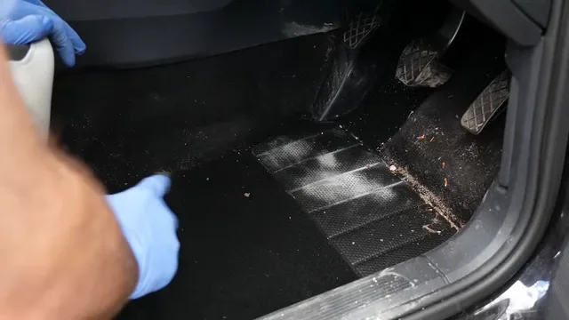 Manguera industrial aspirando la alfombra del interior de un carro